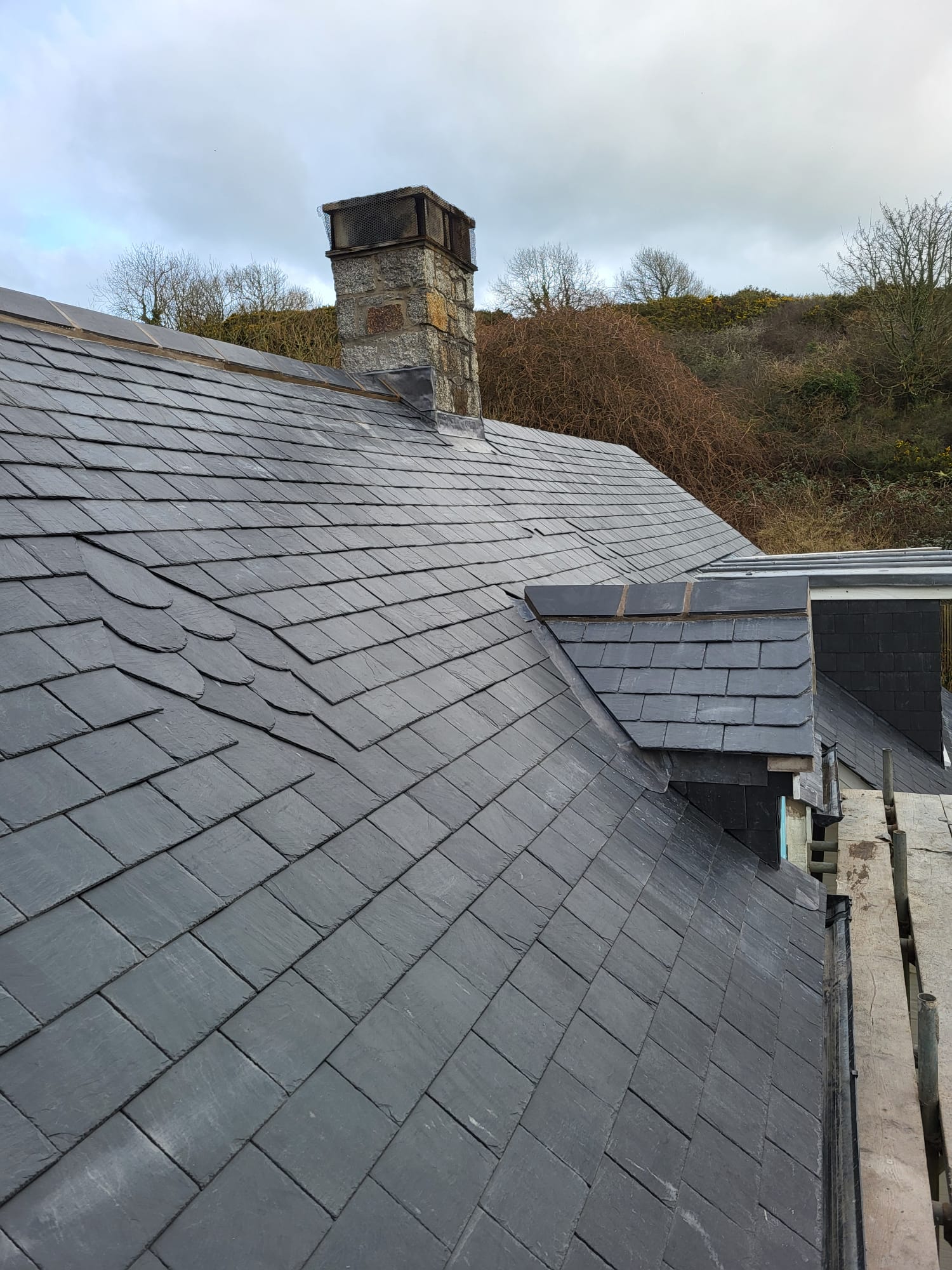 Stone chimney with slate roof and fresh lead flashing